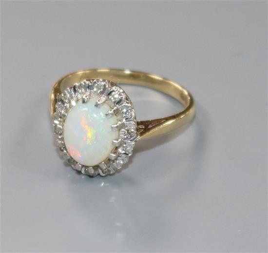 A 9ct gold, white opal and diamond oval cluster ring, size K.